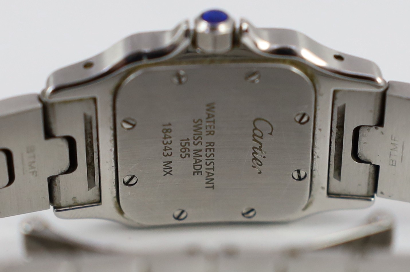 A lady's stainless steel Cartier Santos quartz wrist watch, on a stainless steel Cartier bracelet